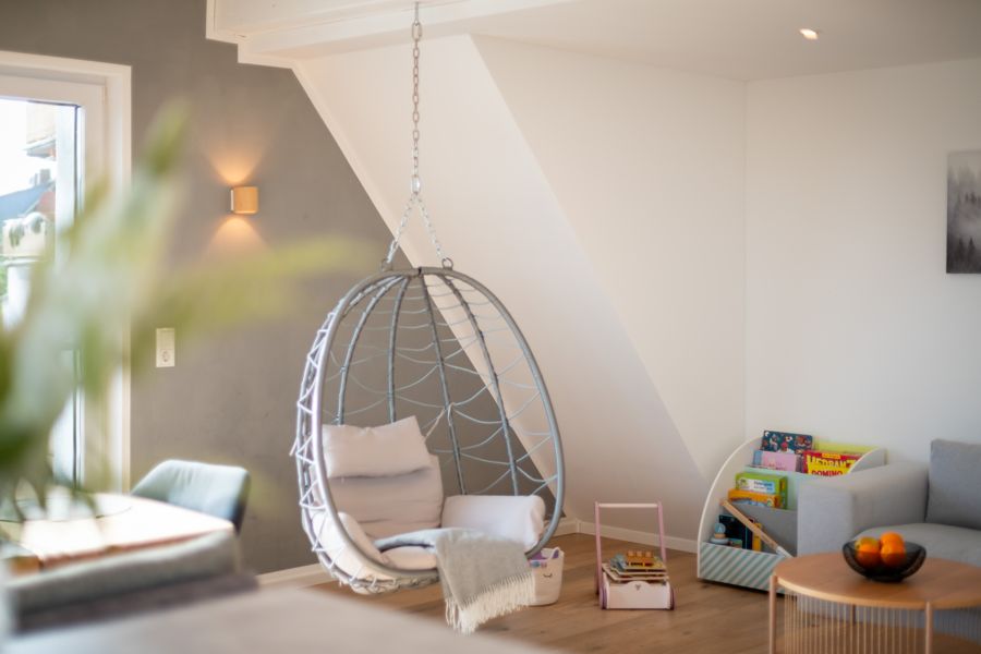 Gemütliche Hängeschaukel-Ecke im Wohnzimmer des Premium Ferienhauses Schauenburg